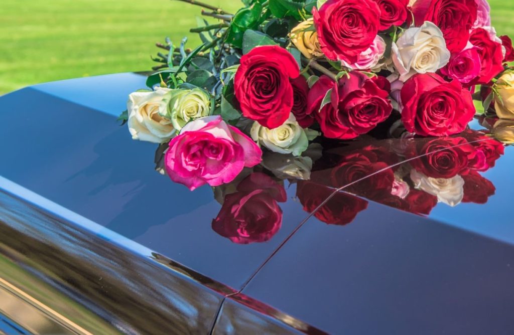 Casket and flowers at cemetery